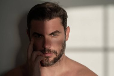 Seksi üstsüz adam, beyaz arka planda izole edilmiş teninin portresini kapat. Yumuşak ciltli, çekici bir adam. Spa terapisi. İnsan, yüz, güzellik ve cilt konsepti
