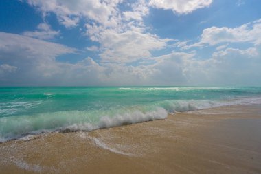Deniz kıyısında okyanus dalgası hareketi. Yaz deniz esintisi. Deniz doğası arka planı. Huzurlu okyanus. Rüya gibi okyanus ufku. Kıyı okyanusu cennet duvar kâğıdı. Deniz köpüğü dalgaları. Gök mavisi su yüzeyi. Altın saat kumsalı