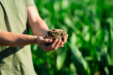 Çiftçiler toprağı tutarlar. Toprak ekime hazır. Ekim mevsimi. Toprağı besleyen humus. Taze toprağın topraksı kokusu. Ön hazırlık. Bereketli toprak ekime hazır. Grunge kirlenmesi
