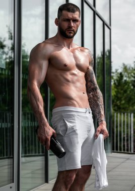 Handsome man preparing for workout. Sport. Weight workout. Guy doing bodybuilding workout in gym. Sport, bodybuilding and fitness. Man exercising with dumbbell. Hard workout