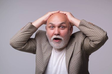 Yüzünde şok ifadesi olan yaşlı bir adamdan şüpheleniyorum. Şok olmuş emekli adam. Yaşlı bir erkek şoka duygusal tepki gösteriyor. Şok olmuş olgun bir adamın portresi. Yaşlanmış adam şokta.