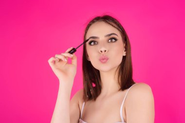 Koyu kaşlı güzel bir kadın kaş fırçası tutuyor. Kaş kaplaması. Güzellik prosedürlerini uygula. Kaş ve kaş çizgisi, kaş çizgisi.