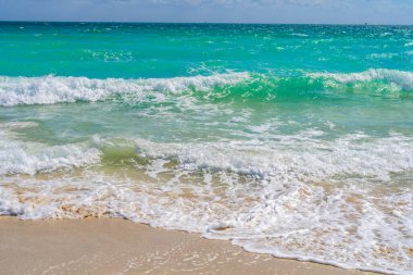 Deniz kıyısında okyanus dalgası hareketi. Yaz deniz esintisi. Deniz doğası arka planı. Huzurlu okyanus. Rüya gibi okyanus ufku. Kıyı okyanusu cennet duvar kâğıdı. Deniz köpüğü dalgaları. Gök mavisi su yüzeyi. Altın saat kumsalı