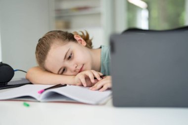 Home study for child. Kid studying on laptop e-learning. Teen student study lesson on laptop. Child study schoolwork in home classroom interior. Online study. Education and studying online