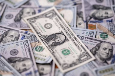 Money background with dollar bills. Texture of US dollars. 100 USD banknotes in focus. American hundred-dollars notes for banner. Pattern of US dollars for finance concept. Dollars currency
