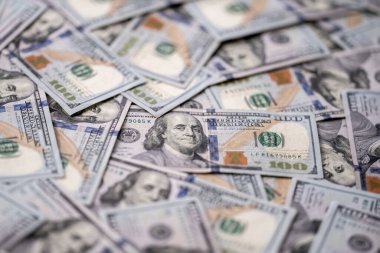 Money background with 100-dollar bills. Texture of US money currency. 100 USD banknotes in focus. American hundred-dollar money. Pattern of US dollars. Money for finance concept