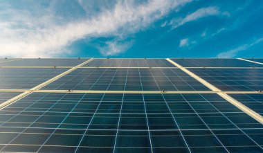 Mavi gökyüzündeki paneller. Yeşil yaşam için güneş çözümleri. Güneş enerjisi yenilenebilir. Güneş paneli ve güneş enerjisi. Paneller güneşin altında parlıyor. Güneş teknolojisi