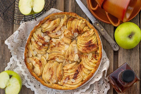 Rustic French sweet apple tart with apples, cinnamon and almonds