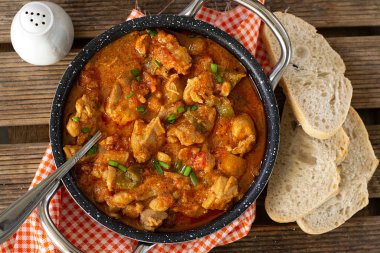 Hungarian traditional dish paprika chicken paprikash with bell peppers clipart