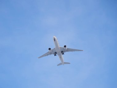 Plane in blue sky: overhead, under plane, landing gear extension, signal fire.