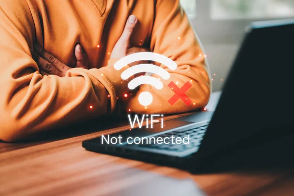 Man using a computer laptop to connect to wifi but wifi not connected, and waiting to loading digital business data form website, concept technology of waiting for connect to wifi.