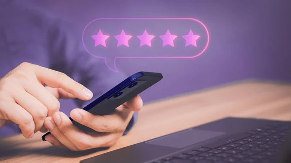 Adult man using a smartphone or mobile phone and give five star symbol to increase rating of product and service concept, Customer service experience, testimonial and business satisfaction survey.