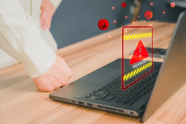 Personal computer virus detected, user data protection, network security and maintenance concept. Man using computer laptop with triangle caution warning sign for notification error.