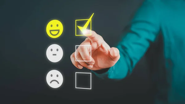 Man touching the virtual screen on the happy smiley face icon to give satisfaction in service. Rating very impressed. Assessment customer service, testimonial and satisfaction concept.