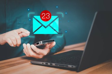 Adult man holding a mobile phone and touching with virtual screen newsletter for electronic mail or E-mail. Email marketing and newsletters, notification alert, technology and internet on smartphone.