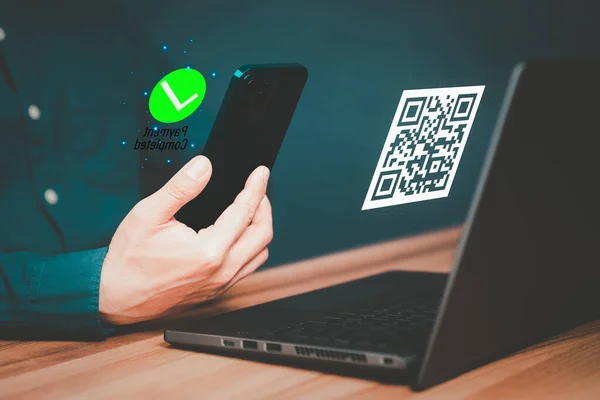 Concept of using smartphones to scan QR codes to make payment. Customer making payment through mobile phone and scan code for online shopping. Use of technology in the daily life of modern people.