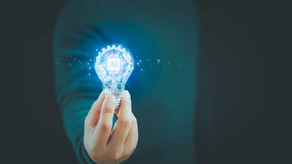 Ai, artificial Intelligence, innovation and inspiration and create idea. Man hand holding illuminated light bulb. Inspiration concept of learning, new knowledge and sustainable business development.