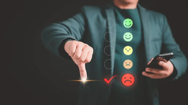 Customer give rating to service experience assessment on application with virtual screen on the angry emotion face. Business concept of customer service, experience dissatisfied, testimonial review.