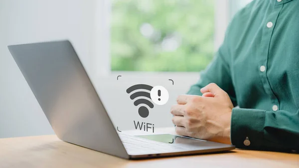 User using a laptop computer to connect to wifi but wifi not working or password is incorrect and waiting to loading digital data form website.Technology concept of wifi connected but no internet.