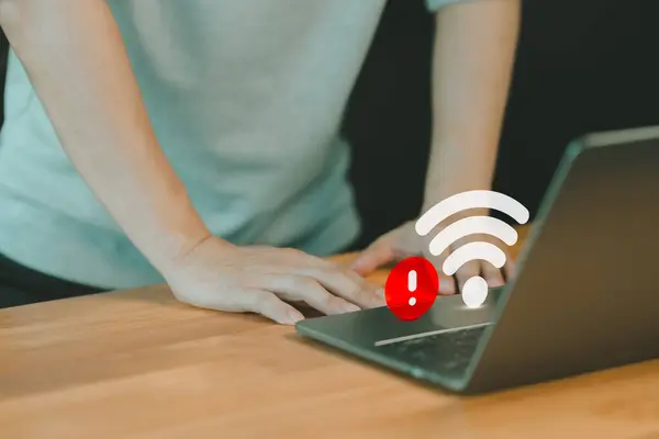 Man using a laptop computer to connect to wifi but wifi not connected or password is incorrect and waiting to loading digital data form website. Technology concept of wifi connected but no internet.