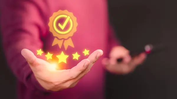 Hand showing the best quality guarantee with five stars. Testimonial, Assurance, Standards, ISO Certification, Review, Feedback and Certification Concept. Assessment quality of business service.