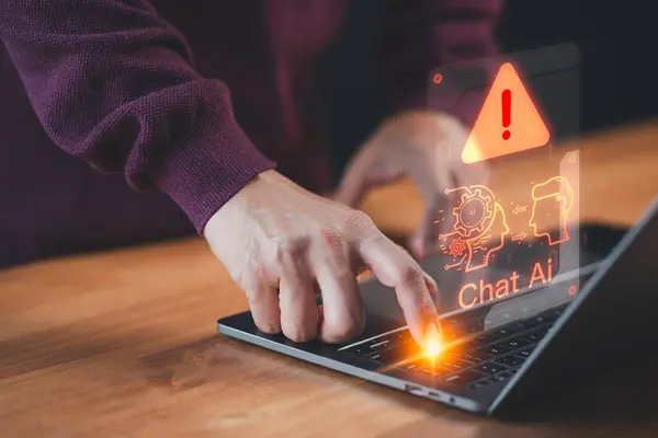 Man using a laptop chatting with smart AI, apps artificial intelligence chatbot with triangle caution warning sign for notification error. Chat with application AI, Artificial Intelligence.