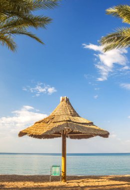 Morning on sandy beach at the Red Sea near Eilat - famous tourist resort and recreation city in Israel