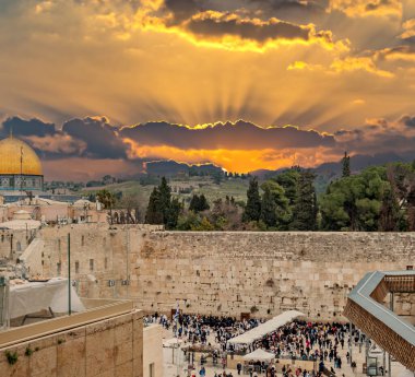 Ancient Ruins of Western Wall is a major Jewish sacred place and one of the most famous domain sites in the world, sunrise with mystic sunbeams in Jerusalem clipart