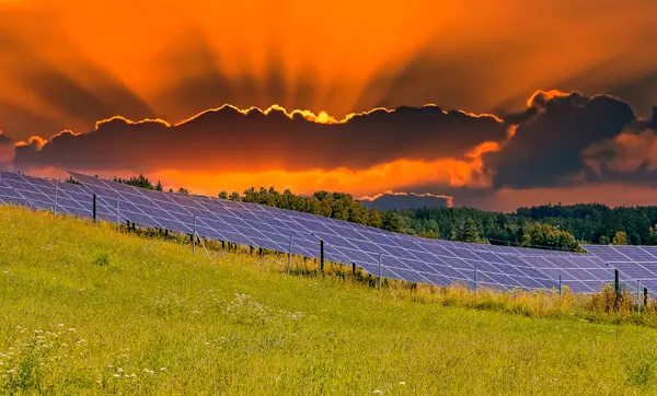 Countryside landscape with cluster of solar panels at the sunrise