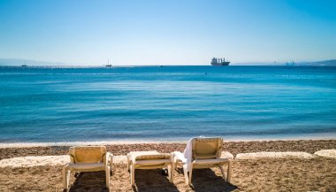 Morning on sandy beach at the Red Sea near Eilat - famous tourist resort and recreation city in Israel