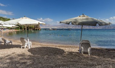 Tropikal kumlu sahilde sabah. Dinlenme ve dinlendirici sandalyeler ve güneş gözlükleriyle. Kızıl Deniz, Orta Doğu 'da halk plajı. Yapay zeka araçları kullanılmadı