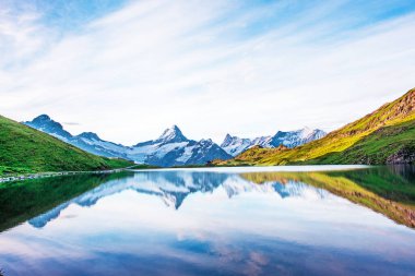 İsviçre Alpleri 'ndeki göl manzarası nefes kesici. Wetterhorn, Schreckhorn, Finsteraarhorn ve Bachsee. Heyecan verici yerler. Panorama.