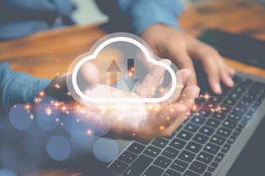 Hand holding virtual cloud computing with a laptop on an old wood table. Technology cloud computing for uploading or downloading internet network, communication wireless. Business, Technology concept.
