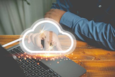 Businessman use a laptop to upload and download by virtual cloud computing on wood table. Technology uploading or downloading internet network, communication wireless. Business, Technology concept.