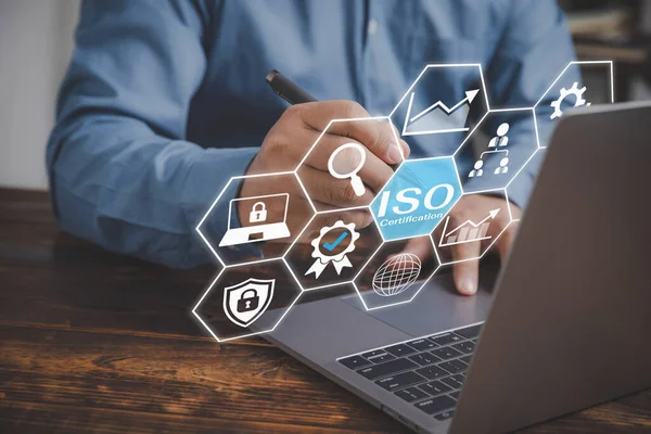 ISO standards quality control concept, assurance warranty. Businessman use a laptop to review and guarantee production for the company. Certification and standardization process, certified business.