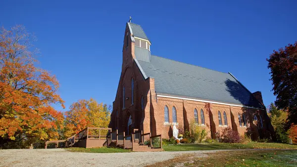 Church in rural community with autumn leaf colour