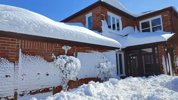 Residential house after a heavy snow storm. Heavy snow on rooftop