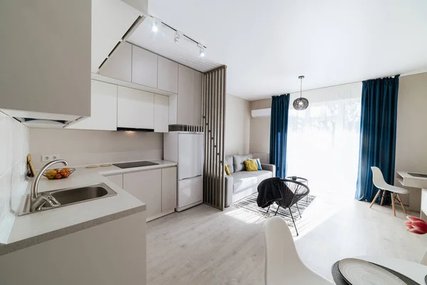 stock image interior design of a Studio kitchen in a new building with a large window and furniture