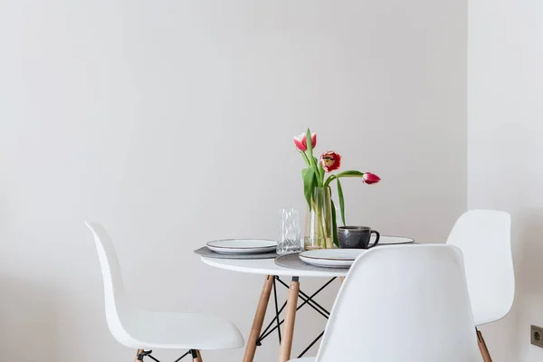 stock image a table with chairs on a white wall background in a new apartment