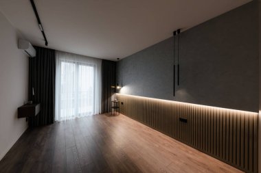 interior design of a room with a large window, lighting and floor