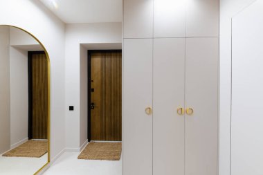 interior design of a light corridor with dark furniture in a new building