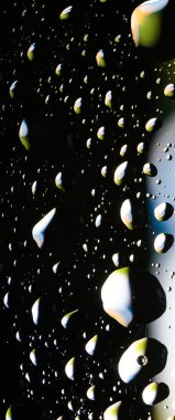 Water drops on glass, raindrops, texture, banner and background, green and white drops