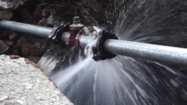 Kırık bir boru birliğinden akan basınç suyu. Uttarakhand Hindistan