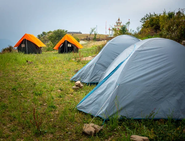 stock image Camps with orange outer fly on a Camp Ground. Nag Tibba, Himalayan region of Uttarakhand. Trekking And Camping