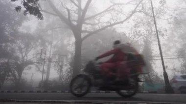 22 Şubat 2024, Dehradun City Uttarakhand, Hindistan. Yoğun sisli trafiği farlarla taşımak, Rajpur Yolu,