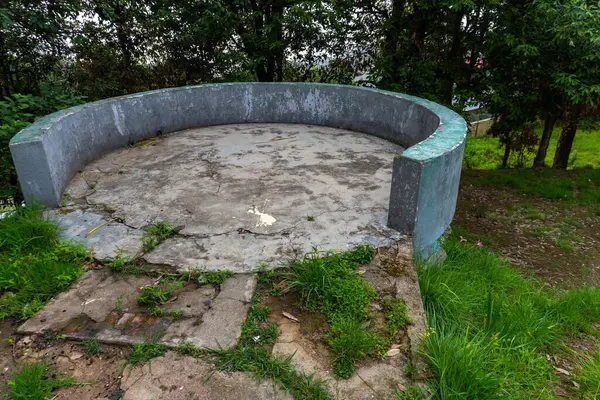 stock image A circular concrete sitting area and bird-watching structure set amid the woods in Uttarakhand, India.