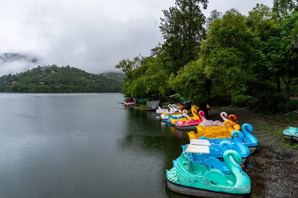 stock image Empty boats lined up on the lakeside at Naukuchiatal Lake during the monsoon season, an off-season period for tourists in Almora, Uttarakhand, India.