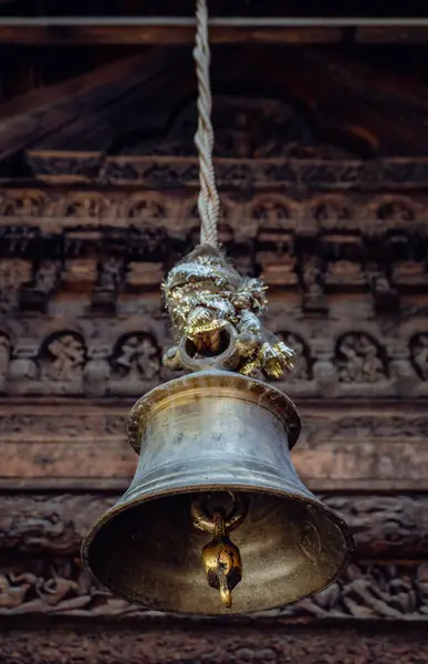 stock image July25th2024, Himachal Pradesh, India. Old bells against century-old carved wooden sculpture at Chaurasi Temple in Bharmour, Chamba, Himachal Pradesh, part of the Manimahesh Kailash pilgrimage.