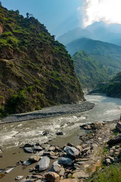 stock image The Ravi River meandering through lush landscapes and valleys of Himachal Pradesh during the monsoon season. A breathtaking view showcasing the natural beauty of India's countryside.