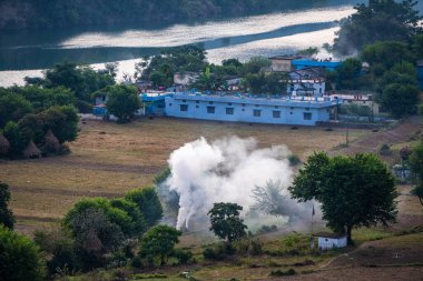 3 Kasım 2024 Uttarkashi Uttarakhand Hindistan. Bhagirathi Nehri kıyısındaki Chinyalisaur 'da köy manzarası, dumanla yanan sakallar tarım alanlarında kirliliğe neden oluyor..